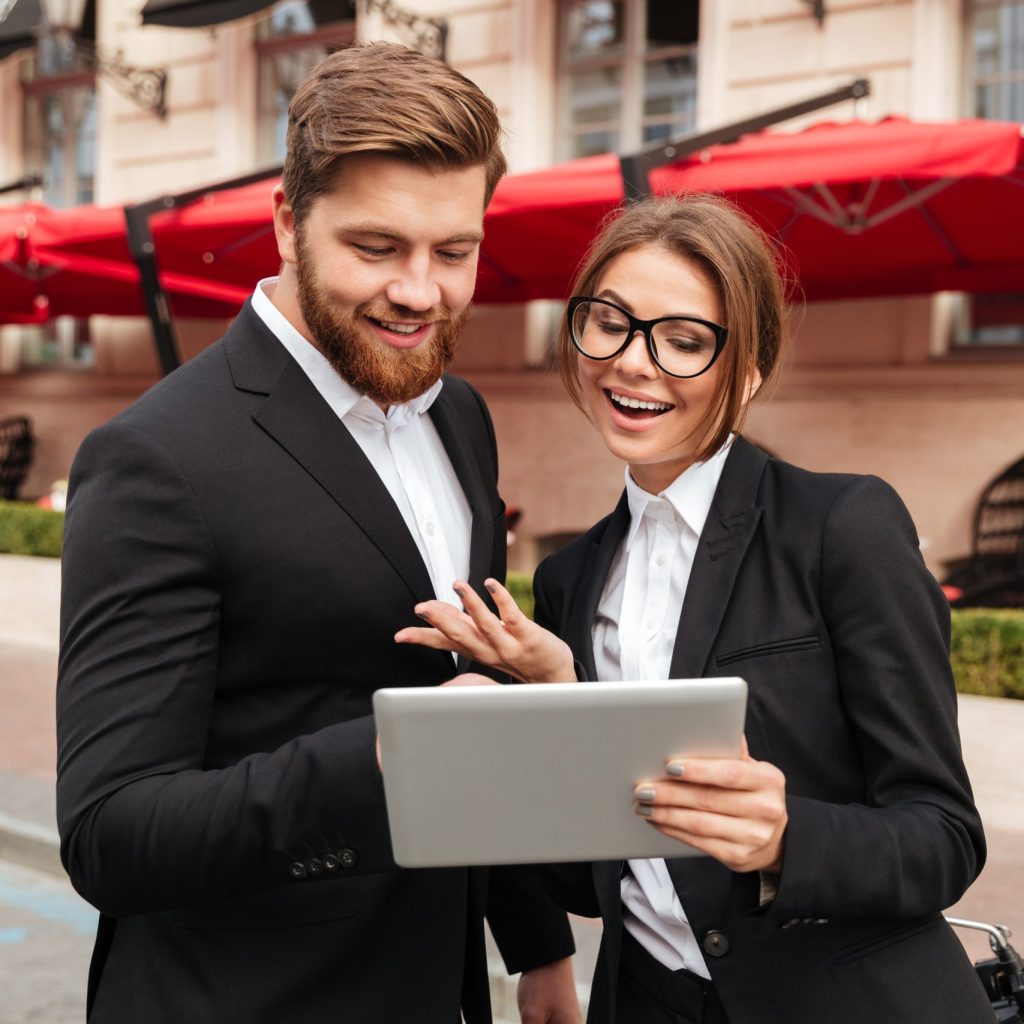 portrait of a happy young couple in smart clothes